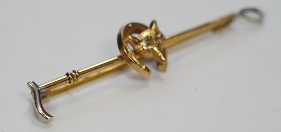 A 9ct and white metal fox head and riding crop tie pin, 56mm, gross weight 2.5 grams. Condition - good